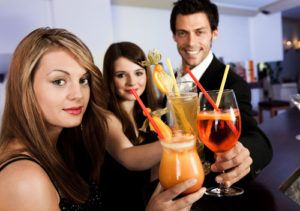 Three People Holding Cocktails